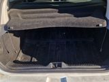 the back of a car with its trunk open and the back of the car filled with luggage