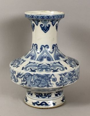 a blue and white vase sitting on a table