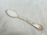 a close up of a spoon on a table with a cloth