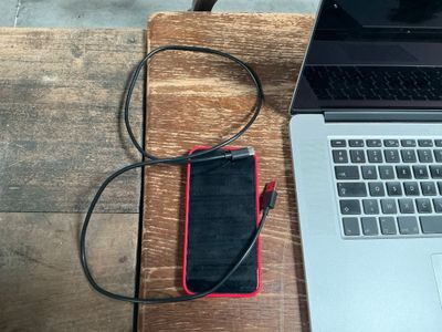 a laptop and a cell phone sitting on a wooden table