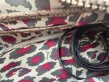 a leopard print purse with a chain on it