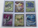 six different pokemon cards are shown in a row on a table