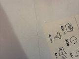 someone is writing on a piece of paper on a table next to a wine glass
