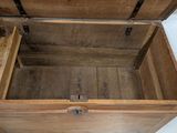 a wooden box with a lid open on the floor