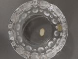 a glass bowl with a candle inside of it on a table