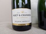 two bottles of champagne sitting next to each other on a table