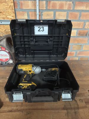 a black tool box with a cordless drill in it on a wooden table