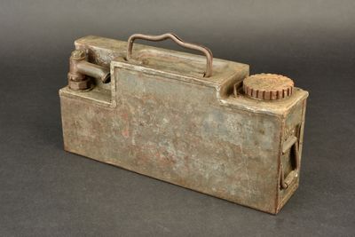 a small metal box with a brush inside of it