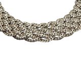a close up of a silver necklace on a white background