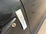 a sticker on the door of a car that has a sticker attached to it