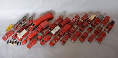 a lot of red toy trucks on a white surface
