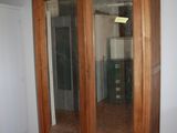 a large wooden cabinet with a mirror on top of it