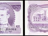 un gros plan sur deux billets sur lesquels figure le portrait d'un homme