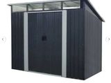 an image of a metal shed with a roof and a door