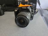 a camera sitting on a counter next to a bag