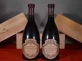 two bottles of wine sitting next to each other on a table