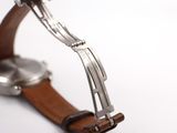 a close up of a watch on a white surface