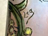 a close up of a vase with a flower design on it