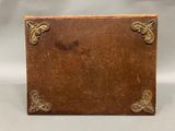 an old leather box with a decorative design on the front