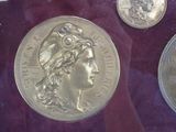 a silver coin with a picture of a woman on it