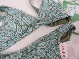 a blue and green bikini set on a white table