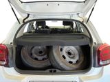 two tires in the back of a car with the trunk open