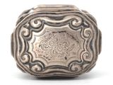 an antique silver ring on a white background with a floral design