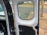 a white van with its door open and a cooler in the back