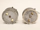 pair of vintage fishing reels on a white background