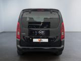 the back end of a black van parked in a room