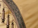 a close up view of a gold and black sari