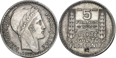 a silver coin with a woman ' s head and laurels on it