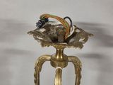 a gold vase that has a bunch of wires in it