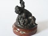 bronze statue of a woman and a dog on a marble base