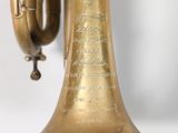 a brass bell that is hanging on a wall
