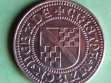 a coin with a coat of arms on it on a green surface