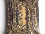 an old decorative tray with a picture of a castle on it