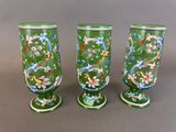three green vases with floral designs on them