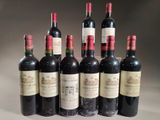 six bottles of wine are lined up in a row on a table
