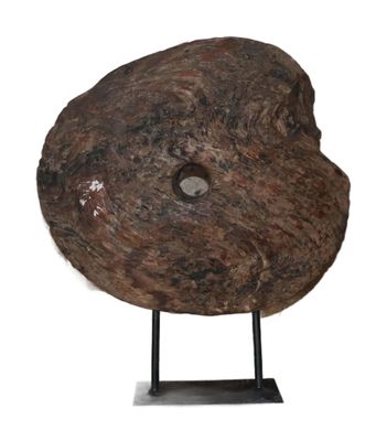 an image of a rock with a hole in it on a stand