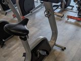 a row of stationary exercise bikes in a gym
