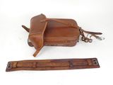 brown leather camera case with strap and strap for a camera