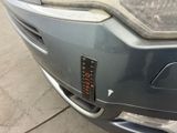a close up of a car ' s front bumper with a sticker on it