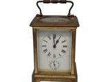 l'image d'une petite horloge dont le cadran comporte des chiffres romains