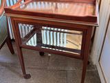 a small table with a glass top on a tile floor