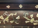 a close up of a wooden box with decorative designs on it