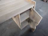 a wooden desk with a drawer on it in a room