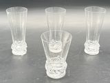 three glasses sitting on a table next to each other