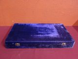 a blue suitcase sitting on a red surface
