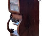 a wooden cabinet with a glass door and a shelf